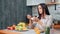 Relaxed smiling morning female having breakfast in kitchen at home