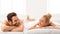 Relaxed Spouses At Spa Lying On Beds Smiling Each Other