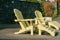 Relaxed style landscaped area in garden yellow Cape Cod style loungers and chairs