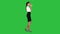 Relaxed stylish businesswoman drinking coffee walking on a Green Screen, Chroma Key.