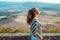 Relaxed stylish traveller woman in front of scenery of Tuscany