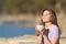 Relaxed teen drinking coffee and relaxing in nature