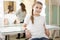 Relaxed teen girl a model sitting in dressing room after casting, mother ready to leave the studio