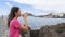 Relaxed Teenager drinking take away coffee looking the sea and thinking about her dreams. Thoughtful fit girl taking a break in a