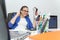 Relaxed and winning business woman sitting with her legs on desk and looking at her shoes