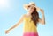 Relaxed woman in colourful dress against blue sky