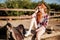 Relaxed woman cowgirl sitting and resting on ranch