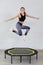 Relaxed woman jumping on trampoline.
