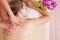 Relaxed woman on massage table receiving beauty treatment at day spa
