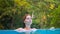 Relaxed woman in open swimming pool. Girl in open swimming pool.