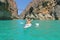 Relaxed woman resting in a kayak in a beautiful lake