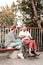 Relaxed woman sitting with disabled man and eating healthy food