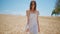 Relaxed woman strolling sunlight farmland. Serene lady touching wheat at harvest