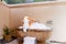 Relaxed woman with towel on head sitting in stone outdoor bath. Sexy girl taking bathtub with bubbles and foam. Back