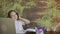 Relaxed young girl with headphones sitting in chair at home