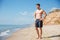 Relaxed young man standing on the beach