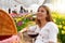 Relaxed young woman between flowers in picnic on spring time. Selective focus