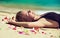Relaxed young woman lying on the sand.