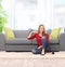 Relaxed young woman sitting by a sofa