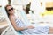 Relaxed young woman on sunbed in pretty summer dress, chilling female in sunglasses enjoy summertime