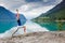 Relaxed young yoga woman in yoga pose near the lake