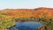 Relaxing aerial footage of a lake and mountains with the colors of Fall in the Laurentians