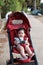 Relaxing Asian children On a red stroller