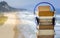 Relaxing with audiobooks during summer holidays with heap of books and vintage headphones. Beautiful beach with ocean waves in the