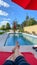 A relaxing backyard swimming pool with red umbrellas