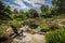 relaxing backyard, with view of the pond and waterfalls in the distance