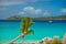 Relaxing on chair on the beach with palm and yacht on background