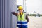 Relaxing engineer man in industry containers cargo, Foreman dock worker in hardhat and safety vest control loading containers box