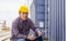 Relaxing engineer man in industry containers cargo, Foreman dock worker in hardhat and safety vest control loading containers box