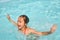 Relaxing girl in water in swimming pool