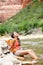 Relaxing hiker woman resting feet in river hiking