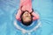 relaxing little girl in a blue rubber pool.