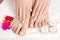 Relaxing Manicure and Pedicure: Serene Beauty with Red Flowers and Candles