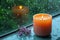 Relaxing moments aroma candles flame glows near a rain drenched window
