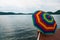 Relaxing with multi-colored sunshade umbrella on a lakeside dock