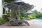 Relaxing rattan chairs with a big umbrella beside the swimming pool