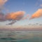 Relaxing scene: moon and clouds over the ocean in a late afternoon view