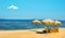 Relaxing spot on seashore beach with straw umbrellas and single