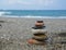 Relaxing in the summer concept. Stones stacked on the beach on sea background