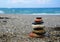 Relaxing in the summer concept. Stones stacked on the beach on sea background