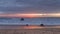 Relaxing Sunset on the beach with orange reflection in the sand