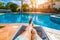 Relaxing at the swimming pool. Man relaxing next to swimming pool. Man enjoying the hot summer at swimming-pool. Sunbathing by the