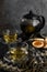 Relaxing tea time concept. Dark mood view of herbal tea and cookies
