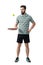 Relaxing tennis player in polo shirt bouncing ball with racket