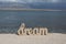 Relaxing time on the beach with sign DREAM