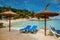 Relaxing under beach umbrellas at Playa de Illetes beach